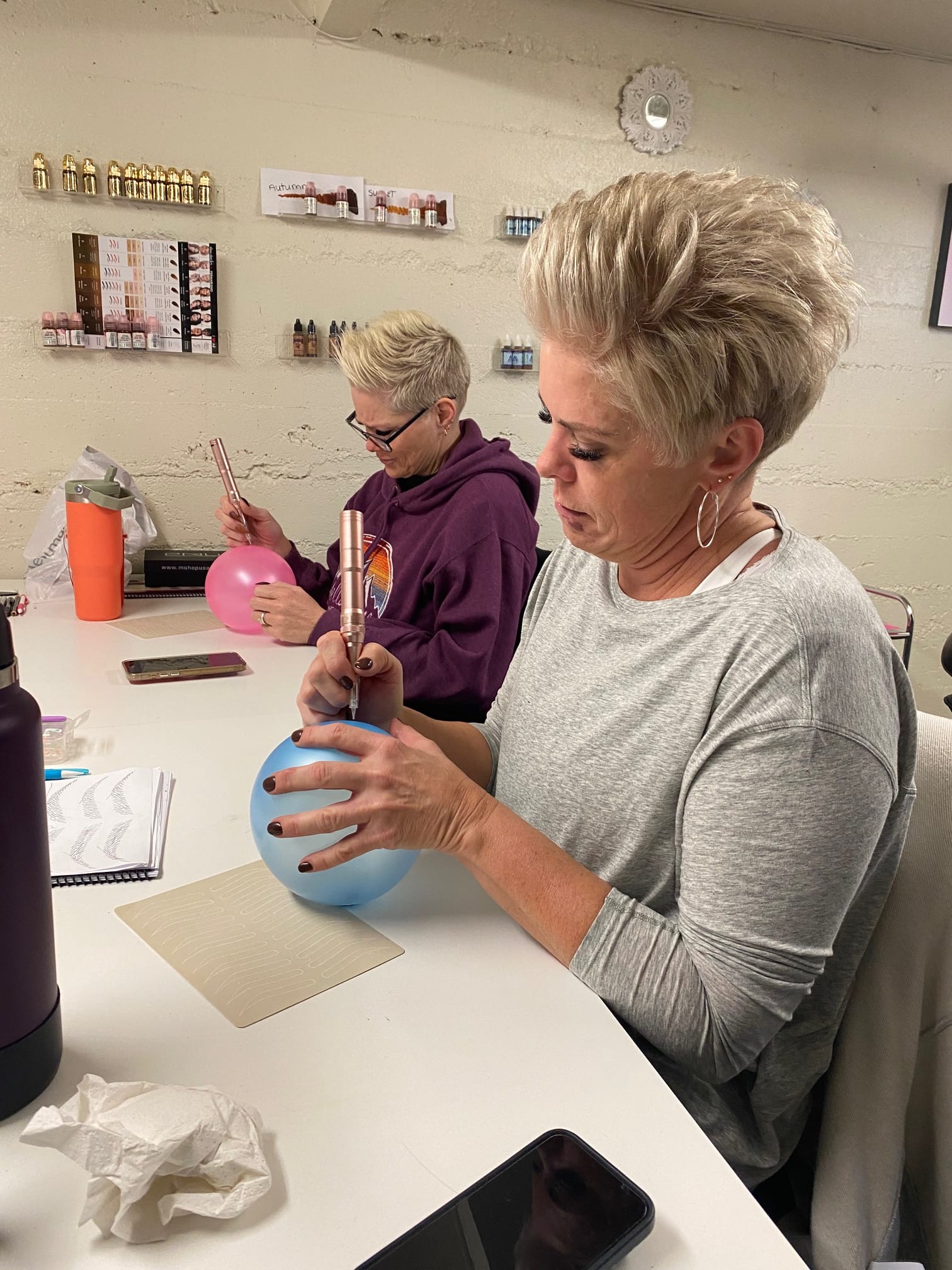 A student performing supervised permanent makeup at Pretty In Ink Brow Academy