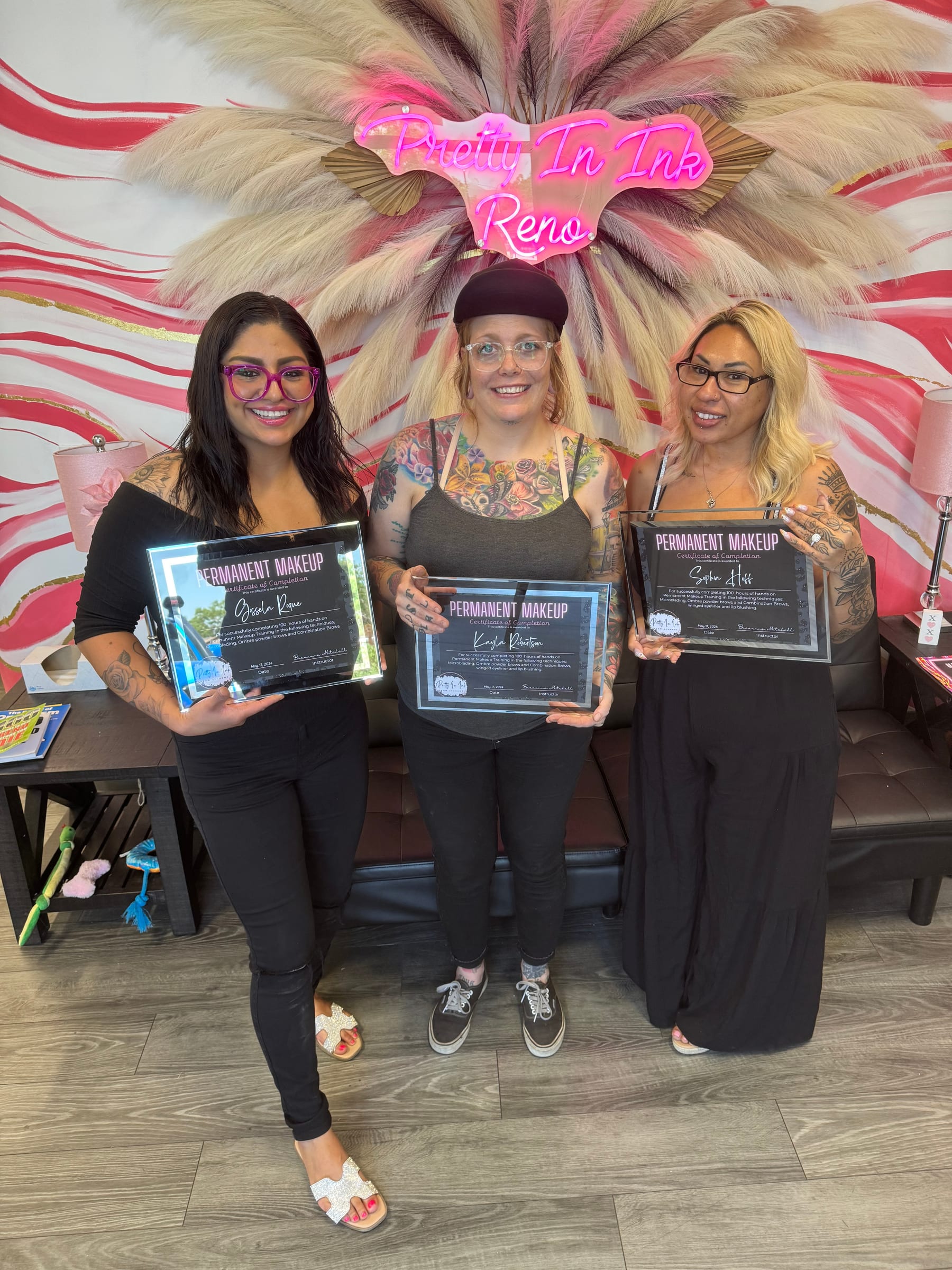 Pretty In Ink Brow Academy students holding their permanent makeup certificates