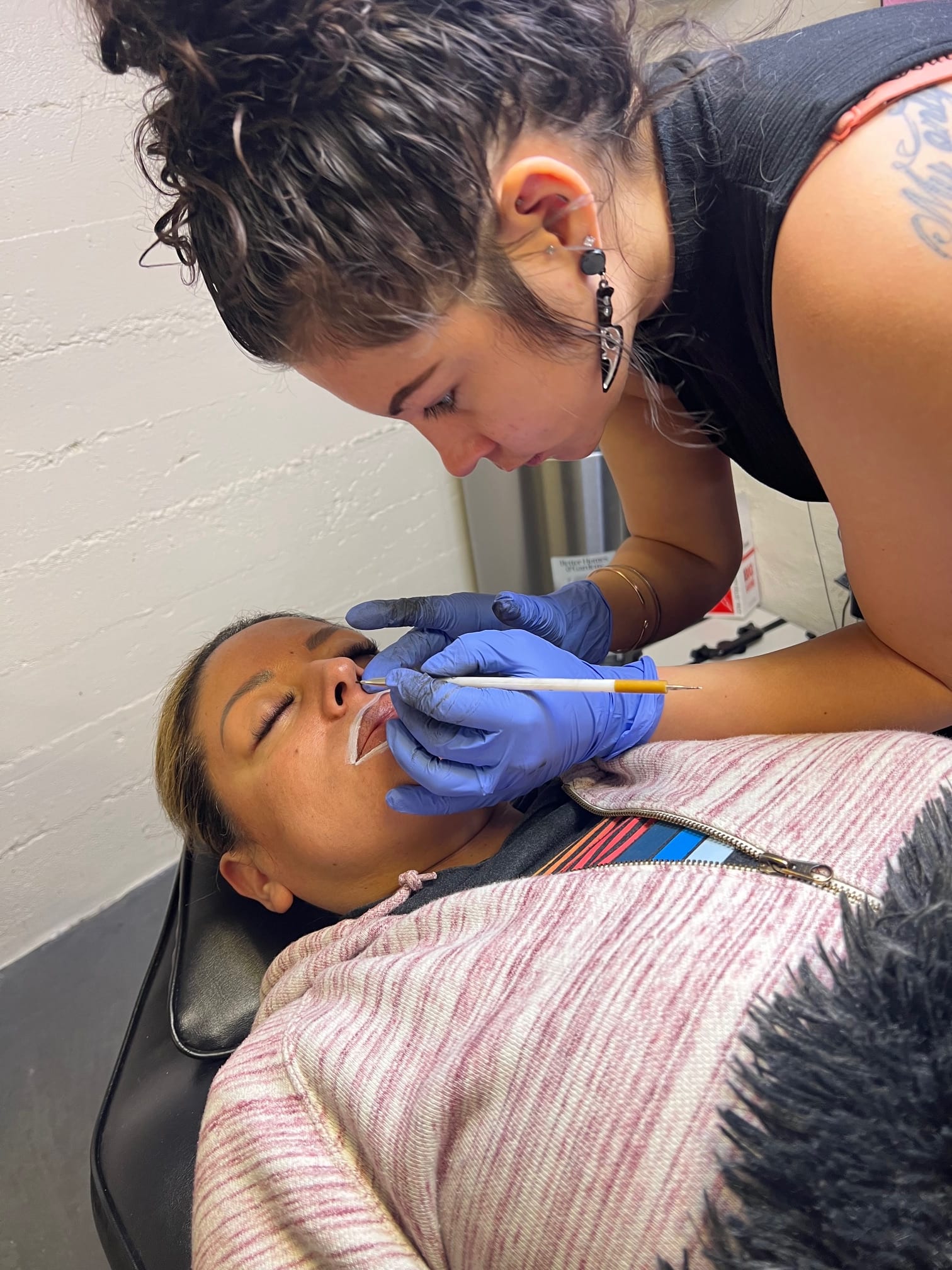 Permanent makeup artist mapping a client's brows at Pretty In Ink in Reno, Nevada
